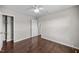 Bedroom with hardwood floors, ceiling fan, closet, and access to other rooms at 4044 Dunkirk Dr, Burlington, NC 27215