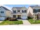 Charming two-story home with manicured lawn, attached garage, and welcoming front porch at 4044 Dunkirk Dr, Burlington, NC 27215
