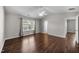 Large bedroom with a ceiling fan, neutral walls and a view of the entryway to the bathroom at 4044 Dunkirk Dr, Burlington, NC 27215