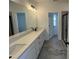 Bathroom featuring a long vanity with double sinks, black fixtures, and a large shower at 4310 Emeline Way # 18, Fuquay Varina, NC 27526
