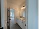 Well-lit bathroom vanity with double sinks, white cabinetry, and modern black fixtures at 4310 Emeline Way # 18, Fuquay Varina, NC 27526