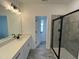 Bathroom featuring a long vanity with double sinks, modern lighting, and a tiled shower at 4310 Emeline Way # 18, Fuquay Varina, NC 27526
