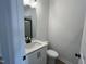 Bathroom featuring a white vanity, toilet, and walk-in shower with dark frame at 4310 Emeline Way # 18, Fuquay Varina, NC 27526
