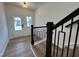 Light-filled entryway with staircase featuring wood and wrought iron railing, blends elegance and style at 4310 Emeline Way # 18, Fuquay Varina, NC 27526