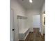 Hallway with coat rack, storage bench, and wood-look vinyl flooring, offers stylish convenience at 4310 Emeline Way # 18, Fuquay Varina, NC 27526