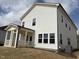 Rear exterior view of a two-story home with a screened-in porch and white siding at 4310 Emeline Way # 18, Fuquay Varina, NC 27526