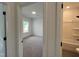Hallway view of a bedroom and bathroom with white walls and carpet at 4310 Emeline Way # 18, Fuquay Varina, NC 27526