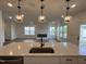 Kitchen island with stainless steel sink and three hanging pendant lights at 4310 Emeline Way # 18, Fuquay Varina, NC 27526