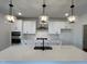 Modern kitchen featuring white cabinets, stainless steel appliances, a large island, and pendant lights at 4310 Emeline Way # 18, Fuquay Varina, NC 27526