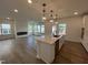 Open-concept kitchen island with stainless steel appliances and pendant lighting at 4310 Emeline Way # 18, Fuquay Varina, NC 27526