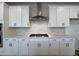 Modern kitchen featuring white cabinets, stainless steel appliances, and a stylish backsplash at 4310 Emeline Way # 18, Fuquay Varina, NC 27526
