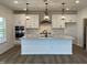 Gourmet kitchen with a large island, stainless steel appliances, and modern pendant lighting at 4310 Emeline Way # 18, Fuquay Varina, NC 27526