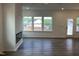 Open living room with wood floors, a fireplace, and abundant natural light from large windows at 4310 Emeline Way # 18, Fuquay Varina, NC 27526