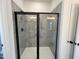Shower featuring glass doors, gray tiled walls, and black hardware, provides a spa-like retreat at 4310 Emeline Way # 18, Fuquay Varina, NC 27526