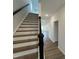 Modern staircase with white risers, wooden steps, and a dark wood banister at 4310 Emeline Way # 18, Fuquay Varina, NC 27526