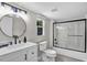 Bathroom with black fixtures, vanity with sink, and shower and tub combo at 4408 Poplar Dr, Raleigh, NC 27610