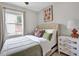 Cozy bedroom with neutral tones, dresser, and bright natural light at 4408 Poplar Dr, Raleigh, NC 27610
