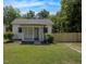 Charming home features a cozy front porch, manicured lawn, and fresh landscaping at 4408 Poplar Dr, Raleigh, NC 27610