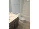 Bathroom with a single sink vanity, toilet, and shower-tub combination at 5016 Gailardia Dr, Zebulon, NC 27597