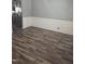 Dining area boasts dark wood-style flooring and wainscoting, adjacent to a modern kitchen at 5016 Gailardia Dr, Zebulon, NC 27597