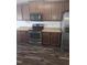 Kitchen with stainless steel appliances, dark cabinets, and dark wood-style flooring at 5016 Gailardia Dr, Zebulon, NC 27597
