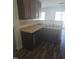 Spacious kitchen sink area with dark wood cabinets and modern dishwasher overlooking the patio at 5016 Gailardia Dr, Zebulon, NC 27597
