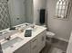 Bright bathroom featuring a double sink vanity, decorative mirrors, and neutral color palette for a serene space at 5045 Kota St, Raleigh, NC 27610