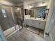 Modern bathroom with double sinks, glass shower, and linen closet at 5045 Kota St, Raleigh, NC 27610