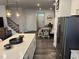 Bright dining and kitchen area showcasing an island with seating and modern stainless-steel refrigerator at 5045 Kota St, Raleigh, NC 27610