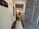 Inviting foyer with gray door, wood floors, and view of kitchen and dining area at 5045 Kota St, Raleigh, NC 27610