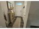 Neutral foyer with wood-look flooring and decoratively furnished with cabinet and lamp at 5045 Kota St, Raleigh, NC 27610