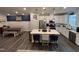 Modern kitchen with stainless steel appliances, island with seating, and separate dining area at 5045 Kota St, Raleigh, NC 27610