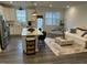 Spacious living room and kitchen featuring an island with seating, stainless steel appliances, and cozy decor at 5045 Kota St, Raleigh, NC 27610