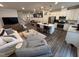 Open-concept living room, kitchen, and dining area with stainless steel appliances and cozy furniture at 5045 Kota St, Raleigh, NC 27610