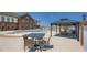 Inviting pool area with tables, chairs, covered gazebo, and a view of the main building for outdoor gatherings at 5045 Kota St, Raleigh, NC 27610