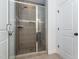 Modern bathroom featuring a glass shower with gray tiling and updated fixtures at 5347 Cypress Ln, Raleigh, NC 27609