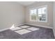 A light-filled bedroom showcasing carpet and large windows offering neighborhood views at 5347 Cypress Ln, Raleigh, NC 27609
