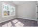 Bright bedroom with neutral walls, carpet, and natural light through large windows at 5347 Cypress Ln, Raleigh, NC 27609