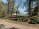 Landscaped path leading to community pool with trees and green foliage at 5347 Cypress Ln, Raleigh, NC 27609