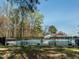 Community pool surrounded by trees, picnic tables and a black fence at 5347 Cypress Ln, Raleigh, NC 27609