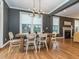 Dining area with hardwood floors, a modern chandelier, and large windows overlooking the outdoors at 5347 Cypress Ln, Raleigh, NC 27609