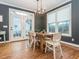 Bright dining room features hardwood floors, stylish lighting, and lots of natural light at 5347 Cypress Ln, Raleigh, NC 27609