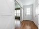 Welcoming entryway featuring hardwood floors, barn door to living room, and a front door with sidelights at 5347 Cypress Ln, Raleigh, NC 27609