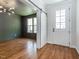 Bright entryway with hardwood floors, front door, and barn door leading to living room at 5347 Cypress Ln, Raleigh, NC 27609