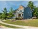 Charming two-story home featuring a blue exterior, a welcoming front porch, and manicured landscaping at 5347 Cypress Ln, Raleigh, NC 27609