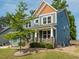 Charming two-story home boasts blue siding, stone accents, and a cozy front porch at 5347 Cypress Ln, Raleigh, NC 27609