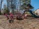 Cozy outdoor fire pit area with Adirondack chairs, perfect for gatherings and relaxing evenings at 5347 Cypress Ln, Raleigh, NC 27609