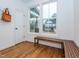 Bright foyer area with hardwood floors, a wooden bench, and a large window providing an exterior view at 5347 Cypress Ln, Raleigh, NC 27609