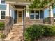 Charming front porch with stone pillars, a wooden door, and manicured landscaping at 5347 Cypress Ln, Raleigh, NC 27609