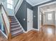 Hallway with a carpeted staircase, hardwood floors, and barn door to another room at 5347 Cypress Ln, Raleigh, NC 27609